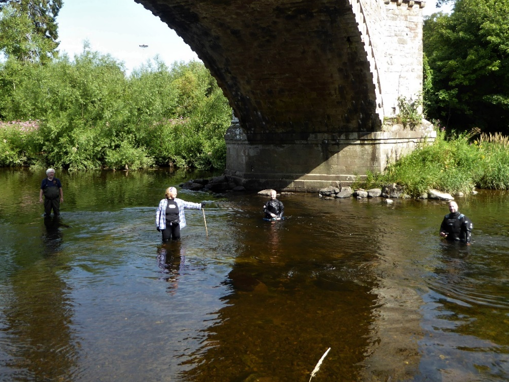 researchers examine the bridge remains