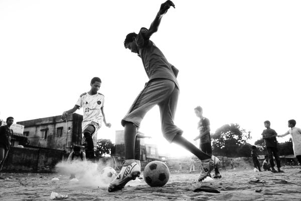 Kids playing soccer on the open field thumbnail