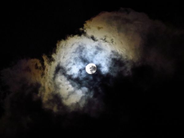 Moon through the clouds late at night thumbnail