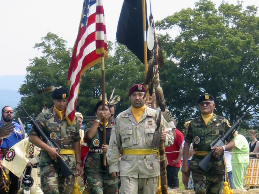 On mid-tour leave from Operation Iraqi Freedom, Sergeant First Class Chuck Boers carries in the eagle staff at the Shenandoah Powwow, 2004. (Courtesy of Chuck Boers)