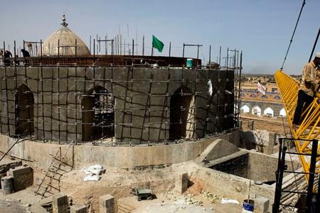 Scaffolding covers the reconstructed golden dome. With help from the U.N. and the Iraqi prime minister's office, workers are rebuilding the sacred Shiite site.