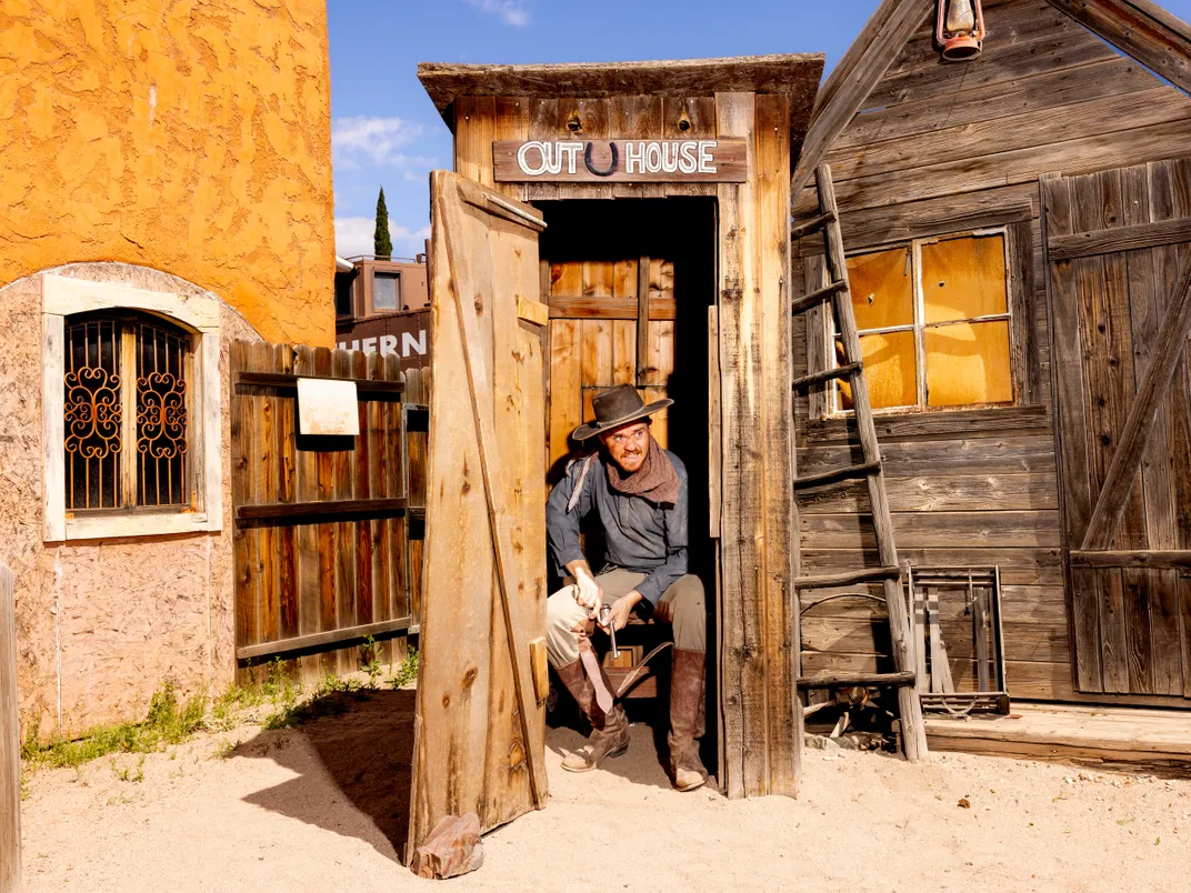 Cade McKechnie sits in an outhouse