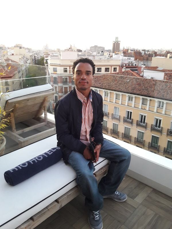 Sitting on the glass balcony in Madrid, Spain. thumbnail