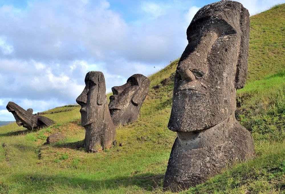 Large head-shaped statues on green island