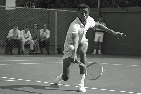 Arthur Ashe&nbsp;playing tennis against Dennis Ralston in 1964