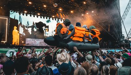 Banksy Takes Credit For an Inflatable Migrant Raft That Floated Across a Glastonbury Crowd