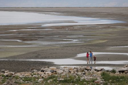 Park visitors walk along a section of the Great Salt Lake that used to be underwater at the Great Salt Lake State Park near Magna, Utah.&nbsp;