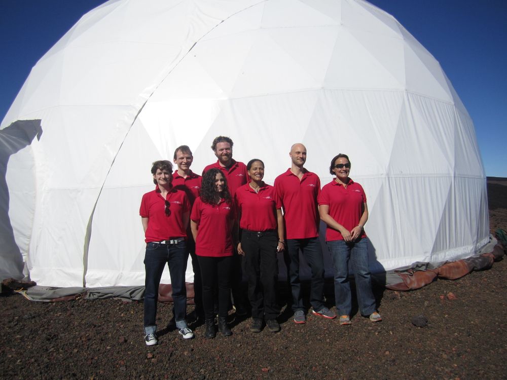 people in red polos outside a HI-SEAS habitat