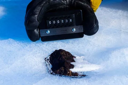 Antarctic meteorite (HUT 18036) is found partially submerged in ice, as opposed to resting atop the surface.&nbsp;