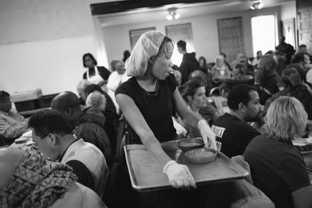 Volunteer Rosheka Robinson serves plates of food to guests at Sister Jean's Kitchen in Atlantic City, New Jersey.