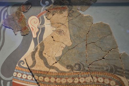 A fragmented painting of a woman bearing offerings, from the Mycenaean palace at Tiryns. 
