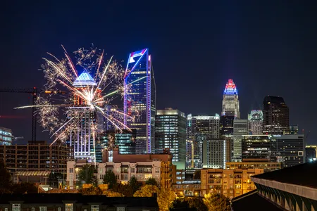 Fireworks over the Charlotte city skyline lit up at night celebrating America's 250th.