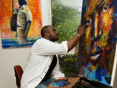 Local artist Jay Coleman works on one of his vibrant, evocative portraits in his studio in Northwest Washington, DC.