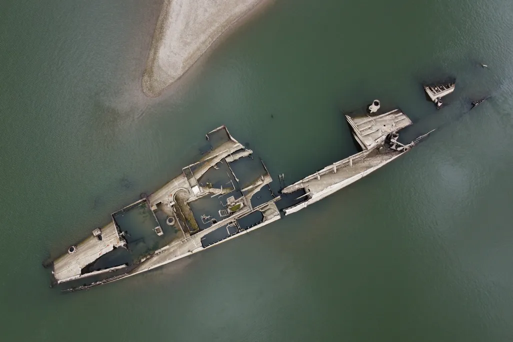 Overhead view of shipwreck partially submerged under water