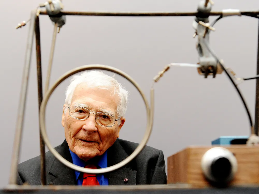 Lovelock looks through one of two wire circles on a small machine