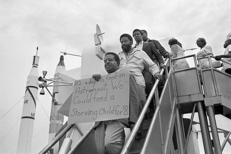 Reverend Ralph Abernathy, Hosea Williams, and other members of the SCLC Poor People's Campaign march through the lunar lander exhibit at Kennedy Space Center before the launch of Apollo 11.
