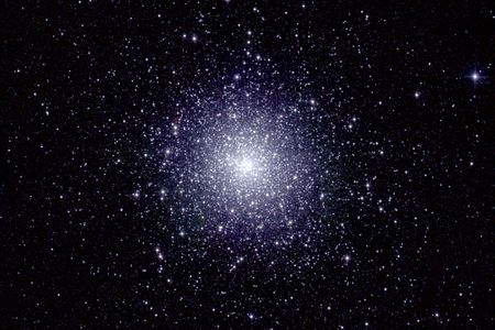 An infrared image of 47 Tucanae, a dense globular cluster of stars located roughly 16,000 light years from Earth. A new study has predicted that a black hole lies at its center.