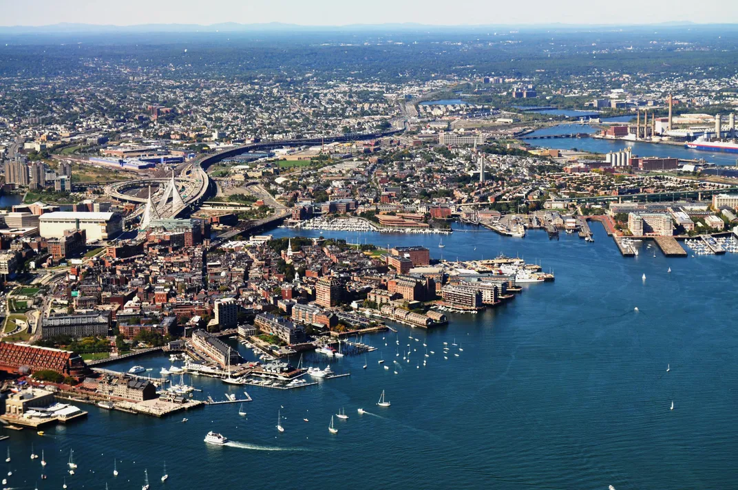 Boats, bridges and skyscrapers are photographed from above Boston Harbor.