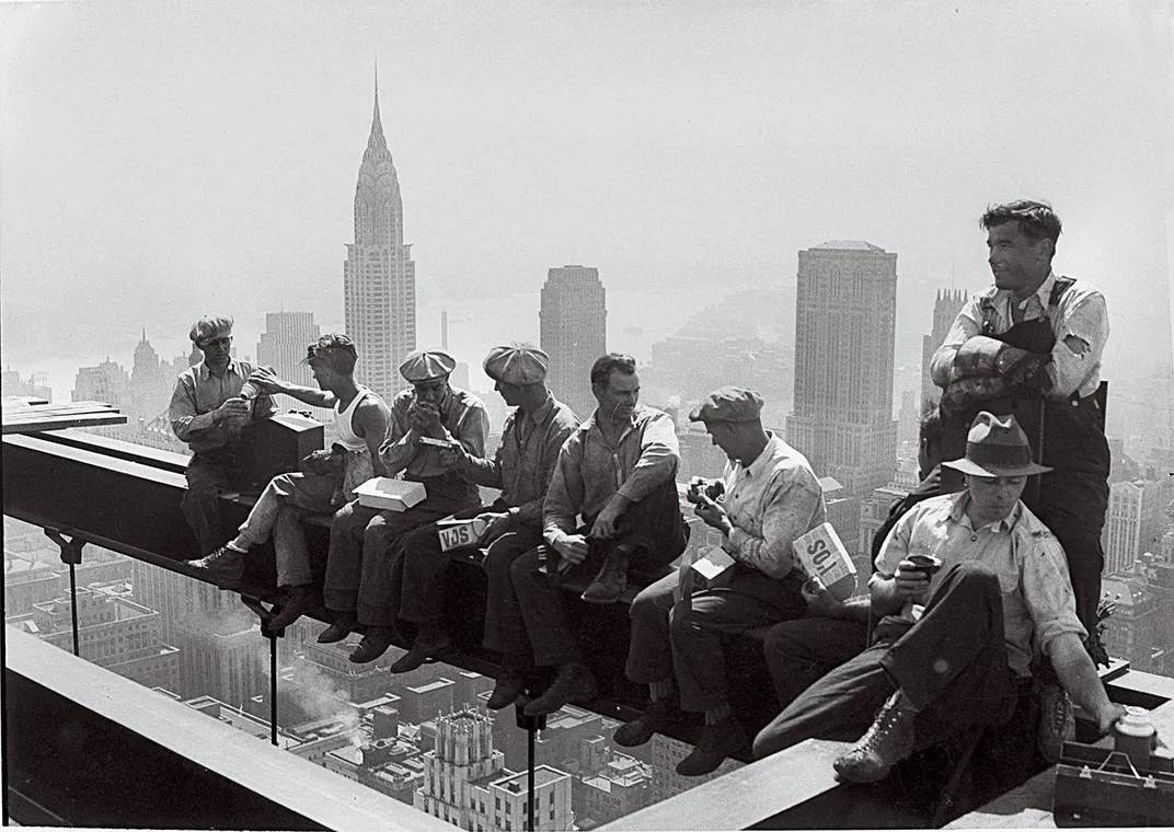 construction workers lunching on a steel beam atop the 66-story RCA Building in New York in September 1932.