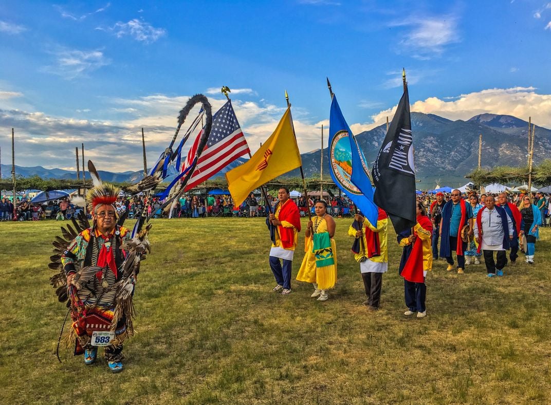 participants take part in a powwow honoring former military members