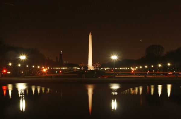 Lights emitted by the Washington Monument and the National Mall are mirrored by the Capitol Reflecting Pool thumbnail