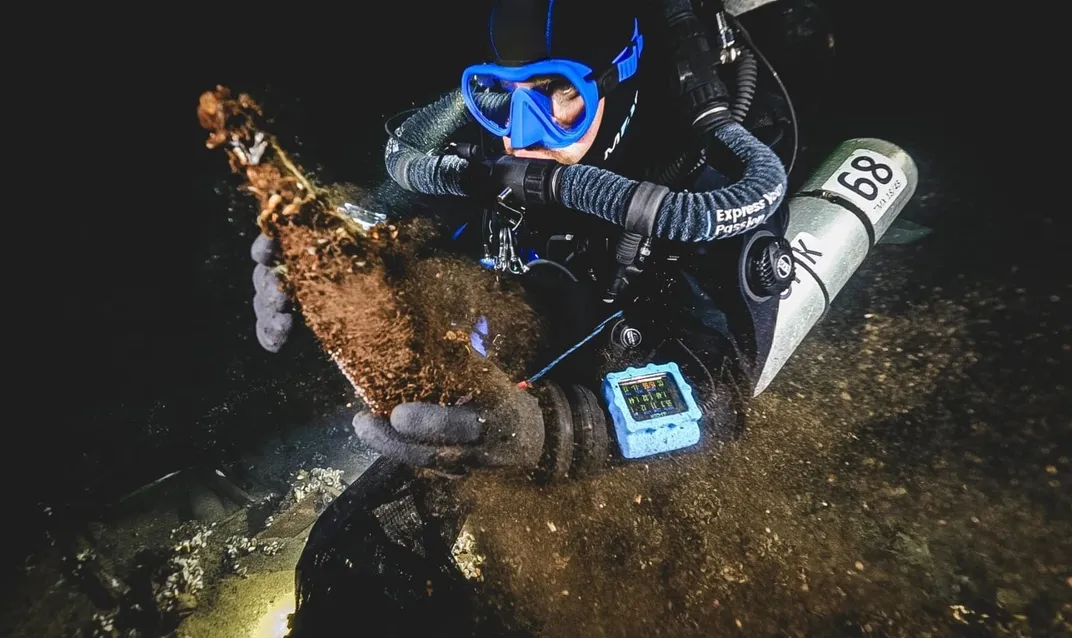 Diver holding bottle