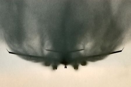 Jerrold Wu 
FINALIST: Civilian Category
The aerodynamic effect of this approach-configured A330 shows water trailing off the fuselage and wings during a heavy afternoon downpour. The relatively bright horizon silhouetted the aircraft and its veil of rain all the way to touchdown.
Changi Airport, Singapore &bull; Photographed December 2012
"Thunderstorms are typical on any given December afternoon in Singapore," says Wu, "but this storm developed so quickly it caught me off guard. I managed to find a bus stop (which happened to be located under the approach path of runway 20R) for some much-needed shelter. As the downpour intensified, aircraft began leaving distinct trails of water streaming off the wings and fuselage."

