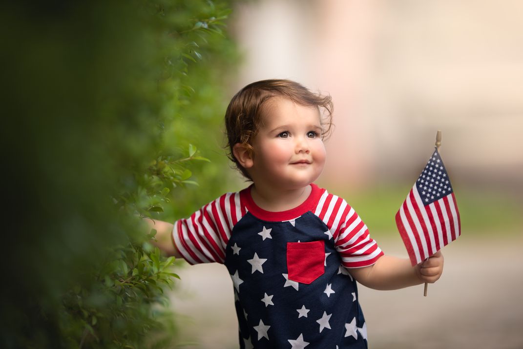 Baby boy holding American Flag for Independence Day | Smithsonian Photo ...