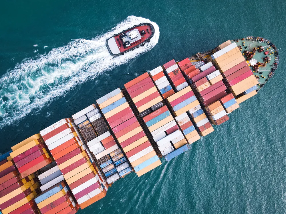 Loaded with colorful containers, a cargo ship floats right into the Port of Miami.