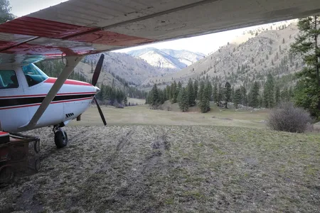 Ahead of the Cessna parked at Central Idaho’s Badley Ranch airstrip, the peaceful canyon doesn’t reflect the difficulty of takeoff and landing here. The strip climbs from a 10- to a 17-degree slope.