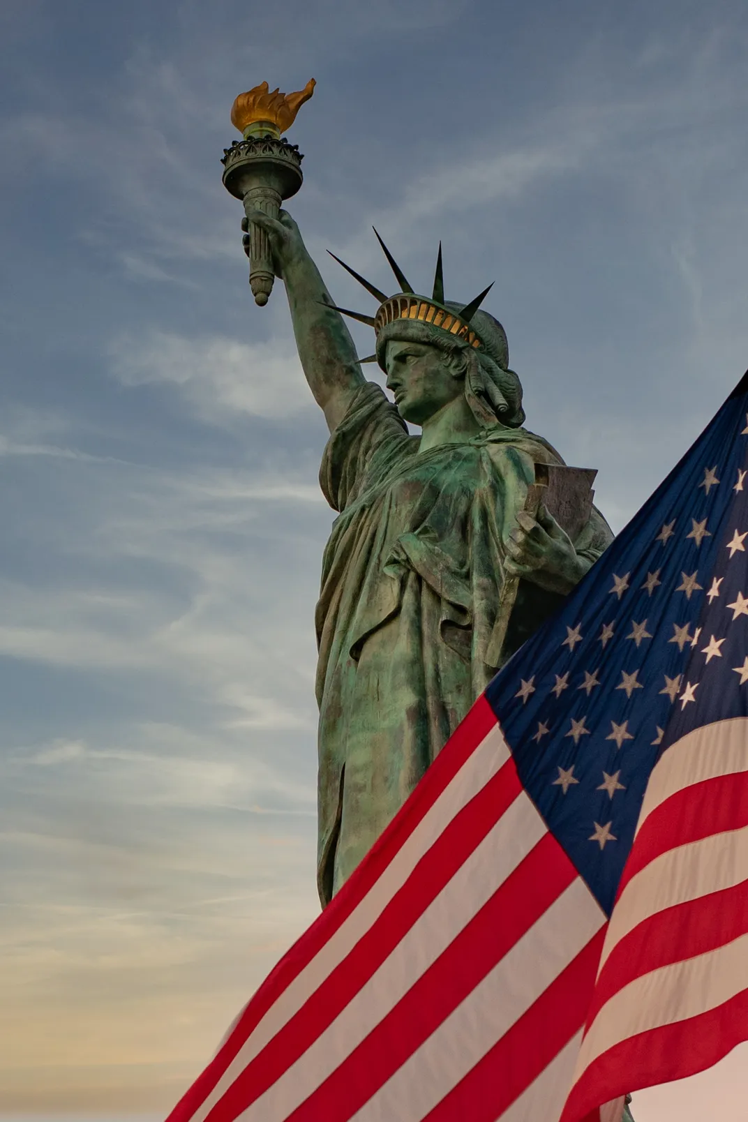 9 - Old Glory wafts in the breeze, sharing the frame with another icon of America, the Statue of Liberty.