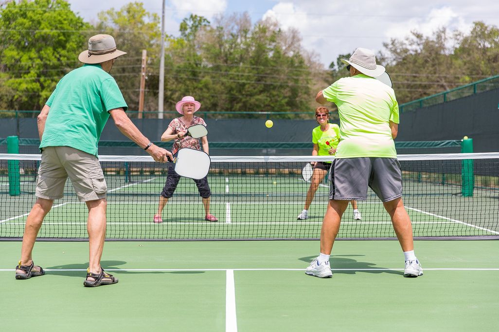 People playing pickleball on an outdoor court