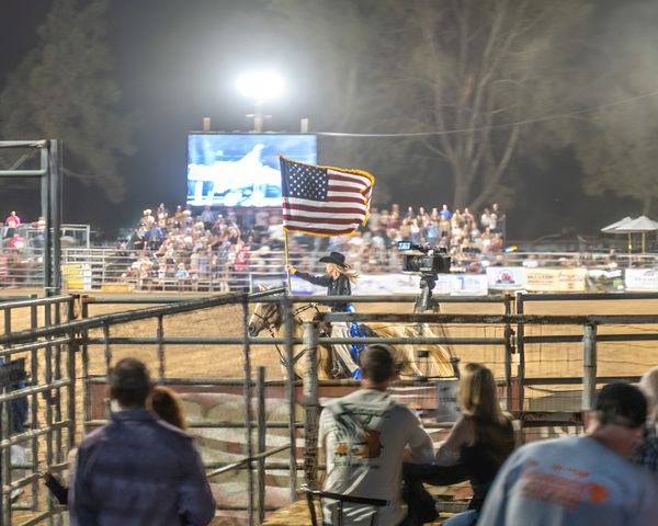 Riding with American flag at Poway Rodeo thumbnail