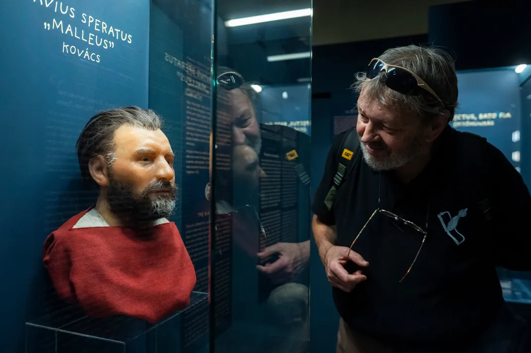 Man looks at facial reconstruction