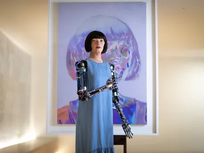 The robot Ai-Da in front of one of its self-portraits.