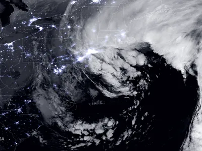 A satellite image shows the huge snowstorm that blanketed the northeastern United States this week. The blizzard was an example of how storms are getting less common but more intense.