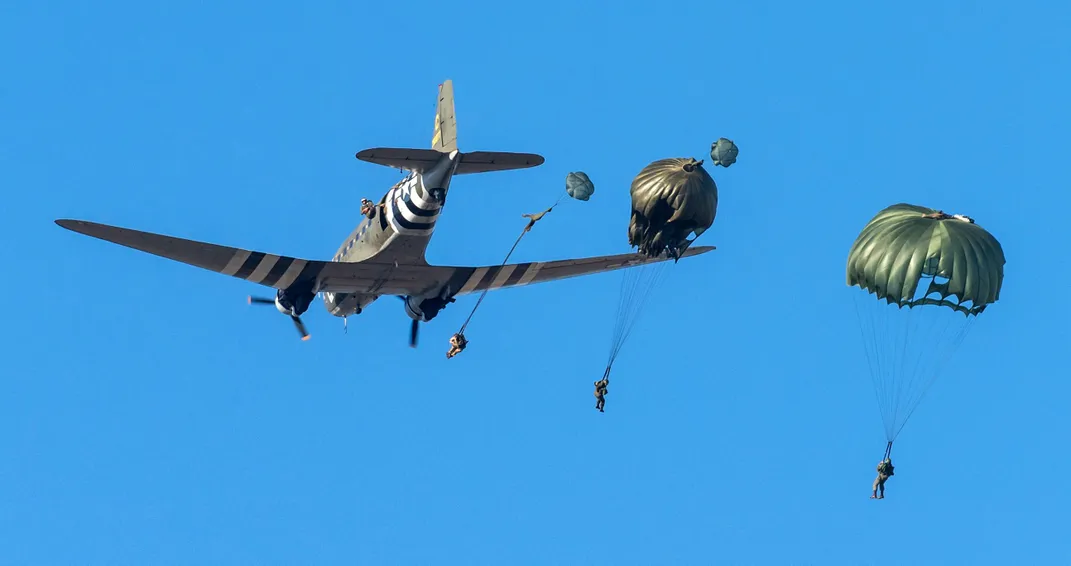 people parachute from a C-47