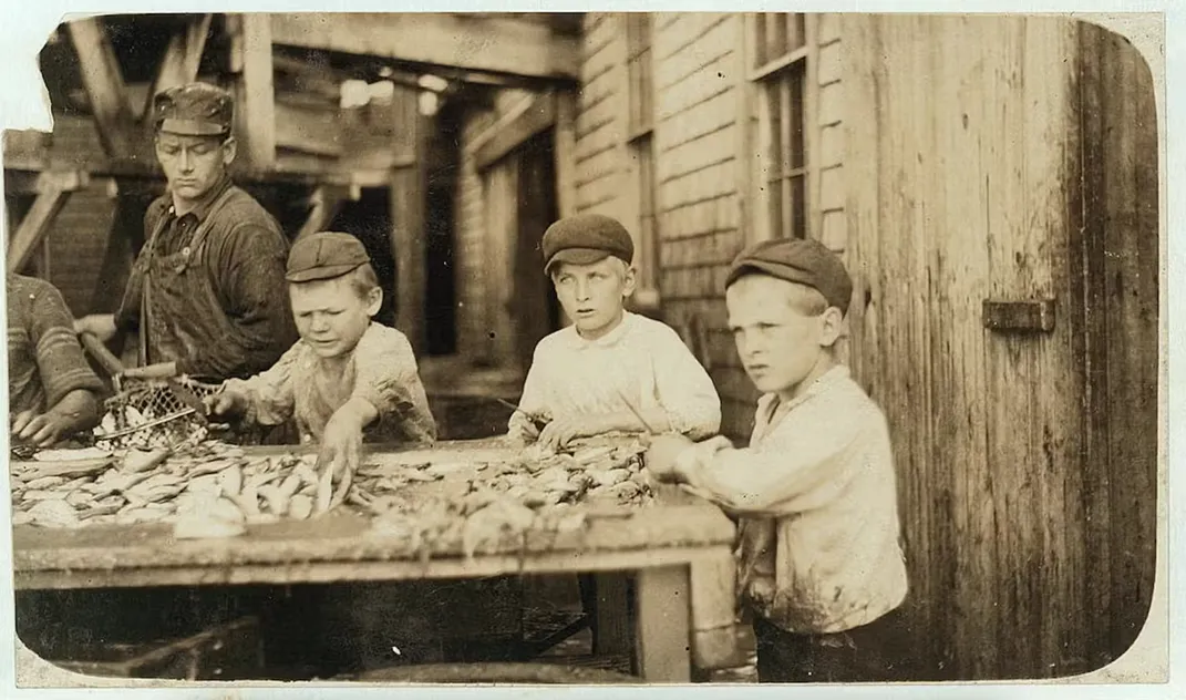 Lewis Wickes Hine’s photograph of three young fish cutters working at the Seacoast Canning Co. in Eastport, Maine