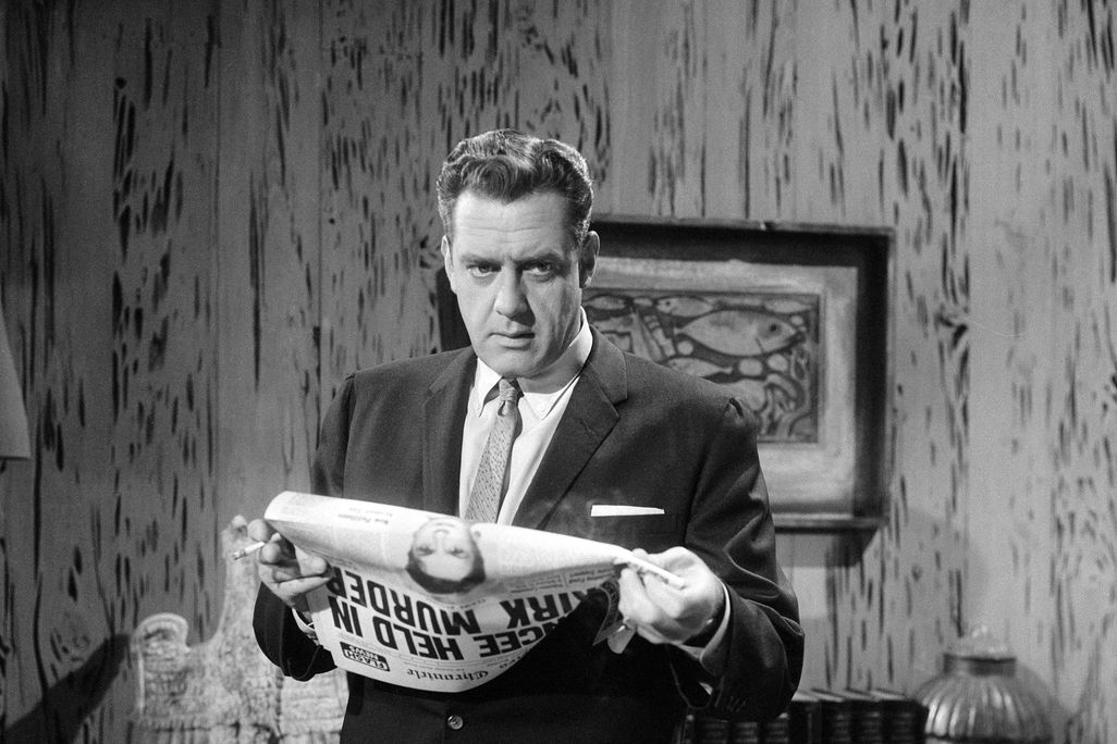 the character Perry Mason holding a newspaper and looking thoughtful