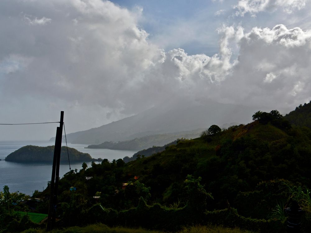A photograph shows La Soufrière volcano surrounded by ash in the distance