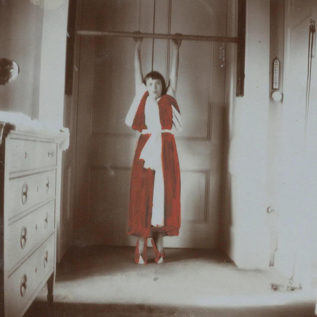 Anastasia hanging from an exercise bar at the Alexander Palace in 1913