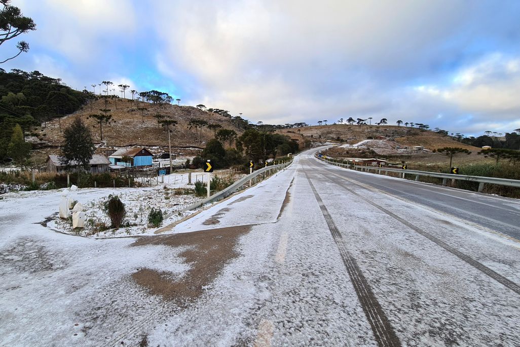 A image of a road leading to Sao Joaquim, Brazil. The road is covered with a thin dust of snow. 