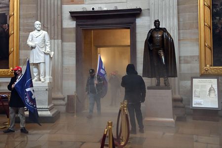 Rioters enter the U.S. Capitol's rotunda as chemical irritants fill the corridor on January 6, 2021. 