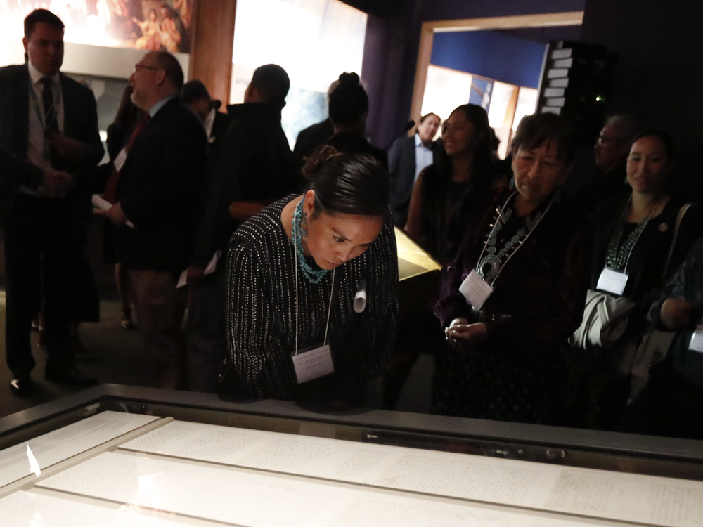 Representatives of the Navajo Nation read the original text of the Naaltsoos Sání, or Navajo Treaty of 1868, after its unveiling in the exhibition 