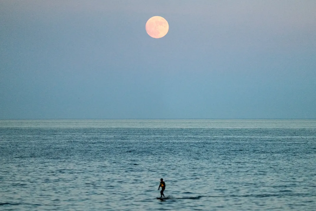 Full moon rises over Humber Bay Arch Bridge in Toronto