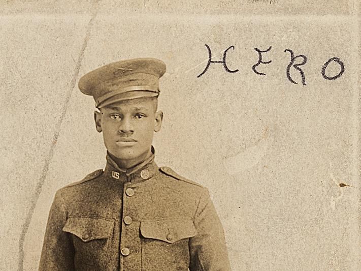Cpl. Lawrence McVey poses at attention in a photographic postcard. 