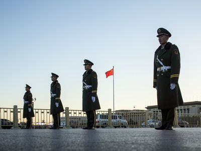 Military police during the ceremonial lowering of the Chinese flag in Tiananmen Square.
