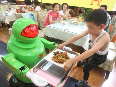 A robot serves a customer at a restaurant in northeast China in 2012
