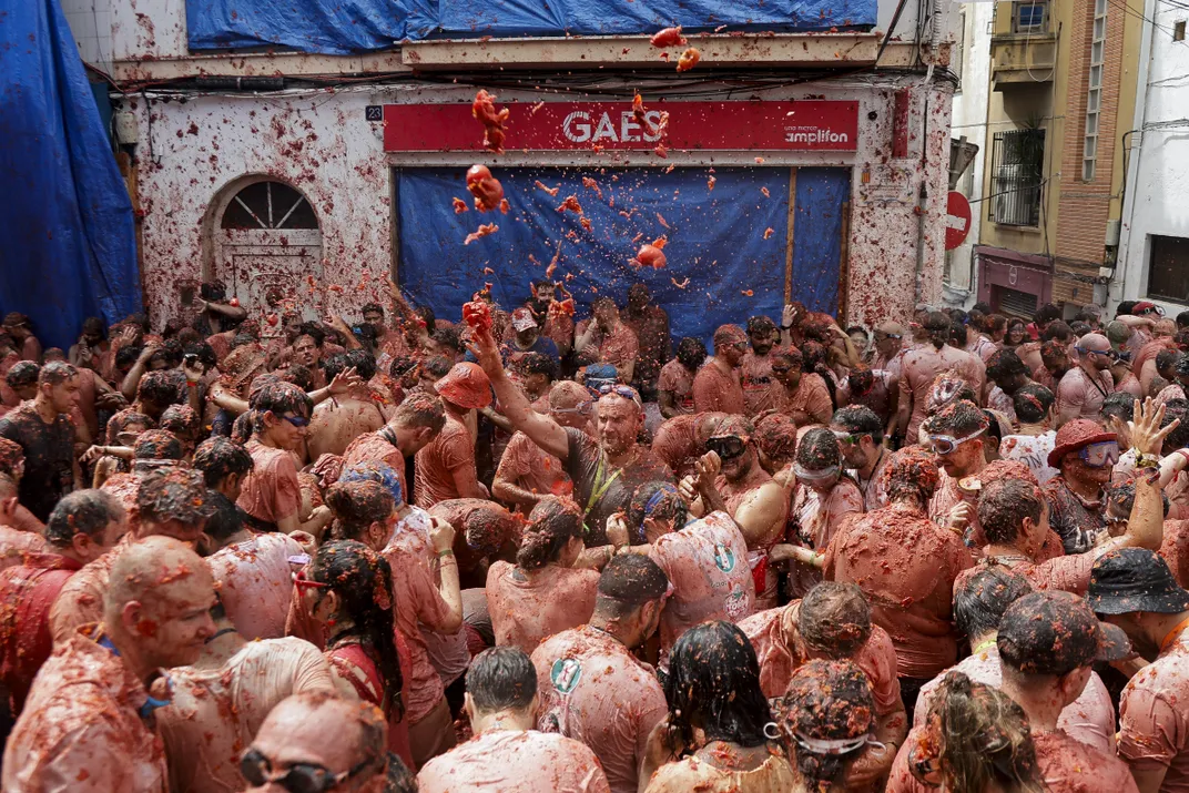 People covered in tomato pulp take part in the Tomatina Festival in Bunol, Spain, on August 27, 2025.