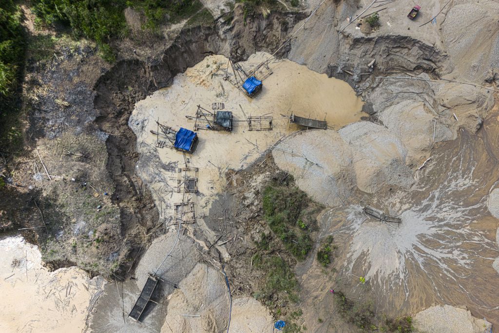 an overhead view of a deforested area with some mining technology set up